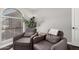Inviting living room with arched window, cozy chairs, and a plant at 5302 W Poinsettia Dr, Glendale, AZ 85304