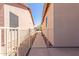 Gated walkway between two homes with rock landscaping and a view of the neighborhood beyond the gate at 5372 S Cat Claw Dr, Gold Canyon, AZ 85118