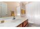 Bright bathroom featuring a vanity with a solid-surface countertop, framed mirror, and shower-tub combo at 5372 S Cat Claw Dr, Gold Canyon, AZ 85118