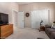 Relaxing bedroom with a sliding closet door, wood dresser, and comfortable seating area at 5372 S Cat Claw Dr, Gold Canyon, AZ 85118