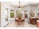 Bright breakfast nook features a ceiling fan and large windows with views of the well manicured outdoor spaces at 5372 S Cat Claw Dr, Gold Canyon, AZ 85118