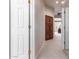 Neutral hallway with carpet flooring features a closet with dark wood doors at 5372 S Cat Claw Dr, Gold Canyon, AZ 85118
