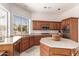 This kitchen is equipped with stainless steel appliances, natural wood cabinets, and a center island with a white countertop at 5372 S Cat Claw Dr, Gold Canyon, AZ 85118