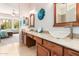 Double vanity bathroom with white vessel sinks, decorative lighting, and tile flooring at 5372 S Cat Claw Dr, Gold Canyon, AZ 85118
