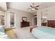 Light-filled primary bedroom offers a sitting area, carpet flooring, and an ensuite bathroom at 5372 S Cat Claw Dr, Gold Canyon, AZ 85118