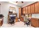 Spacious home office featuring wood cabinets, desk space for two, and tiled flooring at 5372 S Cat Claw Dr, Gold Canyon, AZ 85118