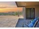 Covered patio with chairs offers a relaxing view of the desert landscape at 553 W Cavalry Rd, New River, AZ 85087