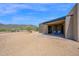 Desert home featuring a covered patio with seating and mountain views at 553 W Cavalry Rd, New River, AZ 85087