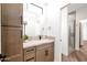 Modern bathroom featuring stone countertop, neutral cabinets, and a glass-enclosed shower at 553 W Cavalry Rd, New River, AZ 85087