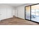 Bright bedroom with sliding glass doors to the patio and a large closet with sliding doors at 553 W Cavalry Rd, New River, AZ 85087