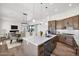 Open concept kitchen featuring stainless steel appliances, a large island, and hardwood flooring at 553 W Cavalry Rd, New River, AZ 85087