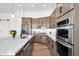 Stylish kitchen boasting stainless steel appliances, granite countertops, and ample cabinet space for storage at 553 W Cavalry Rd, New River, AZ 85087