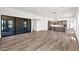 Open-concept living space flows into a modern kitchen, filled with natural light from sliding glass doors at 553 W Cavalry Rd, New River, AZ 85087