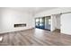 Modern living room with fireplace, sliding doors, and light wood floors at 553 W Cavalry Rd, New River, AZ 85087