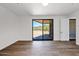 Living room with a wall of glass leading to outdoor patio with desert views and natural sunlight at 553 W Cavalry Rd, New River, AZ 85087