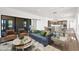 Bright living room with stylish furnishings, a sliding glass door, and an adjacent dining area at 553 W Cavalry Rd, New River, AZ 85087