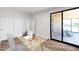 Office featuring a glass desk, an attached backyard patio, and white walls, creating a bright workspace at 553 W Cavalry Rd, New River, AZ 85087