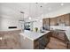 Spacious open floor plan with a kitchen island, modern lighting, and seamless flow to the living area at 553 W Cavalry Rd, New River, AZ 85087