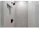 Shower featuring gray vertical tile with black hardware and built-in shelving niche at 553 W Cavalry Rd, New River, AZ 85087