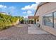 Relaxing backyard featuring a covered patio with gravel landscaping and a vine-covered wall at 5734 W Commonwealth Pl, Chandler, AZ 85226