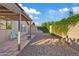 Covered patio with gravel landscaping and vine-covered wall make for a private backyard at 5734 W Commonwealth Pl, Chandler, AZ 85226