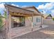 Covered backyard patio with decorative brick pavers and a lush landscape at 5734 W Commonwealth Pl, Chandler, AZ 85226