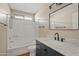 Stylish bathroom features a white-tiled shower, wood vanity, and updated fixtures at 5734 W Commonwealth Pl, Chandler, AZ 85226