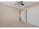 Cozy bedroom features neutral carpet, closet, and open doorway to hardwood hallway at 5734 W Commonwealth Pl, Chandler, AZ 85226