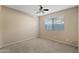 Spare bedroom featuring neutral carpet, ceiling fan, and window with blinds at 5734 W Commonwealth Pl, Chandler, AZ 85226