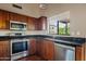 Stylish kitchen with stainless steel appliances, granite counters and wooden cabinets at 5734 W Commonwealth Pl, Chandler, AZ 85226