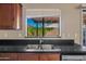 Modern kitchen sink with granite countertop, wooden cabinets, and stainless steel appliances at 5734 W Commonwealth Pl, Chandler, AZ 85226