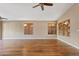 Spacious living room with wood floors, a ceiling fan and plenty of natural light at 5734 W Commonwealth Pl, Chandler, AZ 85226