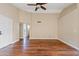 Bright living room featuring wood floors, a ceiling fan and neutral paint at 5734 W Commonwealth Pl, Chandler, AZ 85226