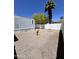 Gravel backyard features convenient gas and water hookups; surrounded by a well-maintained white picket fence at 625 W Mckellips Rd # 325, Mesa, AZ 85201