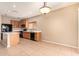 Well-lit kitchen features a center island, black appliances, tile floors, and ample cabinet space at 664 W Silver Reef Ct, Casa Grande, AZ 85122