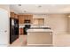 Bright kitchen equipped with an island, black appliances, tile floors, and wooden cabinets at 664 W Silver Reef Ct, Casa Grande, AZ 85122