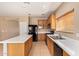 Well-lit kitchen featuring a large island, updated appliances, and ample cabinet space for storage at 664 W Silver Reef Ct, Casa Grande, AZ 85122