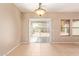 Bright, open living room with tile flooring, backyard access, and ample natural light at 664 W Silver Reef Ct, Casa Grande, AZ 85122