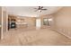 Open living room with adjoining kitchen boasts natural light, tile flooring, and modern fixtures at 664 W Silver Reef Ct, Casa Grande, AZ 85122