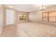 Bright living room featuring neutral paint, carpet, and tile flooring at 664 W Silver Reef Ct, Casa Grande, AZ 85122