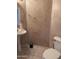 Powder room with a tiled floor features a white sink, toilet, and decorative walls at 6904 E Trailridge Cir, Mesa, AZ 85207