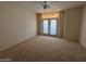 Spacious empty bedroom with ceiling fan and large doors leading to the backyard at 6904 E Trailridge Cir, Mesa, AZ 85207
