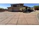 A front yard showing an extra long driveway with pavers leading up to a two car garage at 6904 E Trailridge Cir, Mesa, AZ 85207