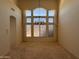 Bright and airy living room features tall windows and chandelier at 6904 E Trailridge Cir, Mesa, AZ 85207