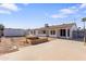 Large backyard with a shed, garden beds, porch, and a home exterior at 7008 W Sierra St, Peoria, AZ 85345