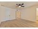 Bedroom with neutral carpet, ceiling fan, and access to other rooms at 7008 W Sierra St, Peoria, AZ 85345