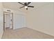 Light-filled bedroom featuring a ceiling fan and closet with mirrored doors for convenience at 7008 W Sierra St, Peoria, AZ 85345