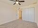 Bright bedroom featuring closet with mirrored doors and a neutral carpet at 7008 W Sierra St, Peoria, AZ 85345