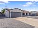 Charming single-story home featuring a gray garage door and a low-maintenance front yard at 7008 W Sierra St, Peoria, AZ 85345