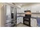Bright kitchen featuring stainless steel appliances, white cabinets, and stylish dark countertops at 7008 W Sierra St, Peoria, AZ 85345